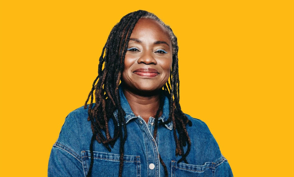 A head and shoulders view of a woman smiling at the camera.