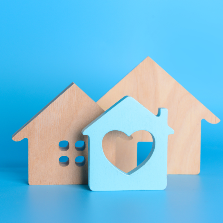 Three 2D wooden houses lined up against a blue background.